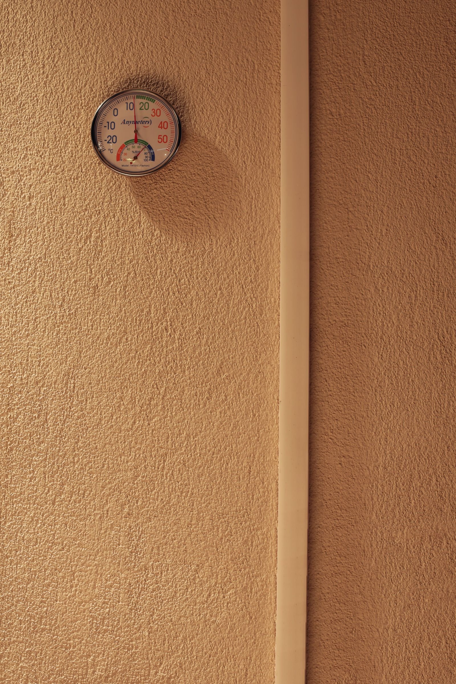 A humidity and temperature gauge mounted on a wall